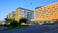 Business district with modern orange corporate buildings, road and parking. Convention and exhibition centre. Urban city life.