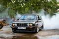 BMW 3-series driftcar burning tires in drift-show Royalty Free Stock Photo