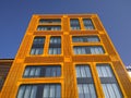 Orange exterior with creative rectangular windows of modern corporate building. Urban architecture. Convention centre. Skyscraper Royalty Free Stock Photo