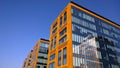 Orange and glass facade of building. Modern architecture. Skyscraper geometry. Business office park. Urban real estate. Economics Royalty Free Stock Photo