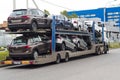 a truck is transporting many new Volkswagen cars on the platform