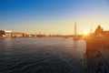 Beautiful evening sunset, visible port cranes and ships in the port on the Neva river, St. Petersburg, Russia. Vasilievsky island.