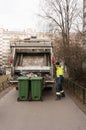 St. Petersburg, Russia - 03.10.20: a worker of a municipal waste recycling plant prepares garbage bins for loading