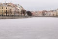 St. Petersburg winter panorama of ice-bound river fountains. People walk on a frozen river in the city center