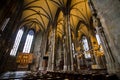 St. Stephen`s Cathedral in Wien, interior of temple with etched windows, altar and benches for believers, sun rays shine on exhib