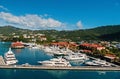 Yachts moored at sea pier on mountain landscape. Sea port and town on sunny blue sky. Luxury travel on boat, water Royalty Free Stock Photo