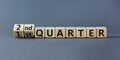 From 1st to 2nd quater symbol. Turned wooden cubes and changed words `1st quater` to `2nd quater`. Beautiful grey table, grey