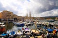 View over boats and ships on promenade of mediterranean Harbour on cloudy day Royalty Free Stock Photo