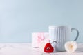 Blue cup with hot drink, white tender roses flowers, red lock in form of heart and box with gift Royalty Free Stock Photo