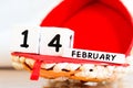 St. Valentine February 14 calendar of wooden cubes from the eternal calendar. Wooden background