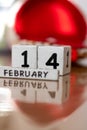 St. Valentine February 14 calendar of wooden cubes from the eternal calendar. Wooden background