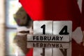 St. Valentine February 14 calendar of wooden cubes from the eternal calendar. Wooden background