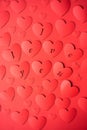 Valentine`s day concept. The background is red, the red hearts are cut out of paper. Words I love you