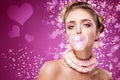 St valentine`s day. Portrait beautiful young blond girl blowing pink heart from bubble gum. On red holiday Royalty Free Stock Photo