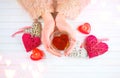 St. Valentine`s Day. Young woman hands holding heart shaped tea cup over wooden background