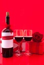 St Valentine`s setting with present and red wine
