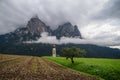 St Valentine's Church, Seis am Schlern, Italy. Schlern mountain with rainy clouds in background