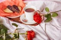 St Valentines breakfast in bed among red traditional roses - vegan heart shaped cookies and coffee cup on the sheets Royalty Free Stock Photo