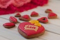 St. Valentines composition. Red glazed honey cakes on wooden table