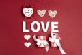 St. Valentines Day background with word love, alarm clock, gifts and decorative hearts on red Royalty Free Stock Photo