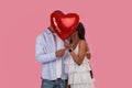 Young Romantic Black Couple Kissing Hiding Behind Red Heart Balloon Royalty Free Stock Photo