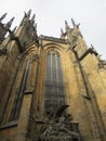 St. Vitus Cathedral in Prague, Czech Republic, side view. Gothic architectural style. In the foreground is a sculpture.