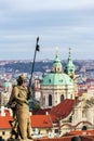 St. Wenceslas Statue in front of the Prague castle, city skyline wit St. Nicholas Church in background Royalty Free Stock Photo