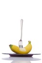 Stab banana with fork