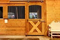 Stable barn with beam ceiling and door to a clean stall. Royalty Free Stock Photo