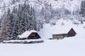 Stable, cowshed for cows and horses. Farm building built of stones and wood. Winter mountain landscape in the Alps. Royalty Free Stock Photo