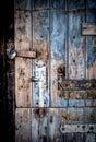 Closeup of a door with a distressed paint finish and a rusted door handle Royalty Free Stock Photo