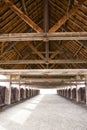 A stable with a wooden roof.