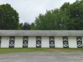 Stables at a horse track with trees and dirt road Royalty Free Stock Photo