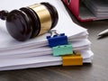 A stack of accounting papers and gavel. Financial white-collar crime and embezzlement. Royalty Free Stock Photo