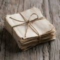 A stack of aged papers tied with rustic string on wooden surface