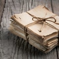 A stack of aged papers tied with rustic string on wooden surface