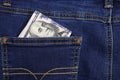 A stack of American hundred dollar bills in the back pocket of blue jeans. Money in your pocket, cash Royalty Free Stock Photo