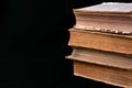 Stack of ancient books with yellowed shabby pages