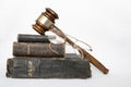 Stack of Antique Worn Leather Bibles with Gavel and Glasses on W