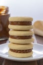 Stack of Argentinian alfajores made with cornstarch filled with dulce de leche