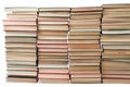 Stack of artistic old books stacked on white background