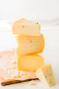 Stack of assorted cheeses  on white background Royalty Free Stock Photo