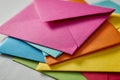 Stack of assorted colorful envelopes arranged in a fan pattern on a light surface symbolizing communication and creative Royalty Free Stock Photo