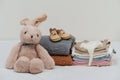 stack of baby clothes and shoes and toy on bed Royalty Free Stock Photo