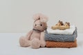 stack of baby clothes and shoes and toy on bed Royalty Free Stock Photo