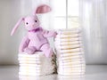 Toy bunny sitting on Stack of disposable diapers or nappies,Stack of diapers,pampers.