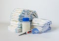 Stack of baby disposable diapers, Pacifier and electronic thermometers over white background. Royalty Free Stock Photo