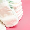 Stack of baby disposable diapers on pink background Royalty Free Stock Photo