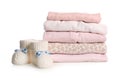 Stack of baby girl`s clothes and booties on white Royalty Free Stock Photo