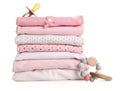 Stack of baby girl`s clothes, pacifier and rattle on white background Royalty Free Stock Photo